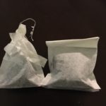 two tea bags tied differently